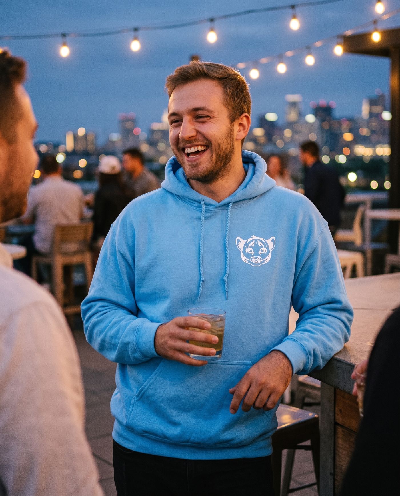 The Cub Hoodie in baby blue on a rooftop