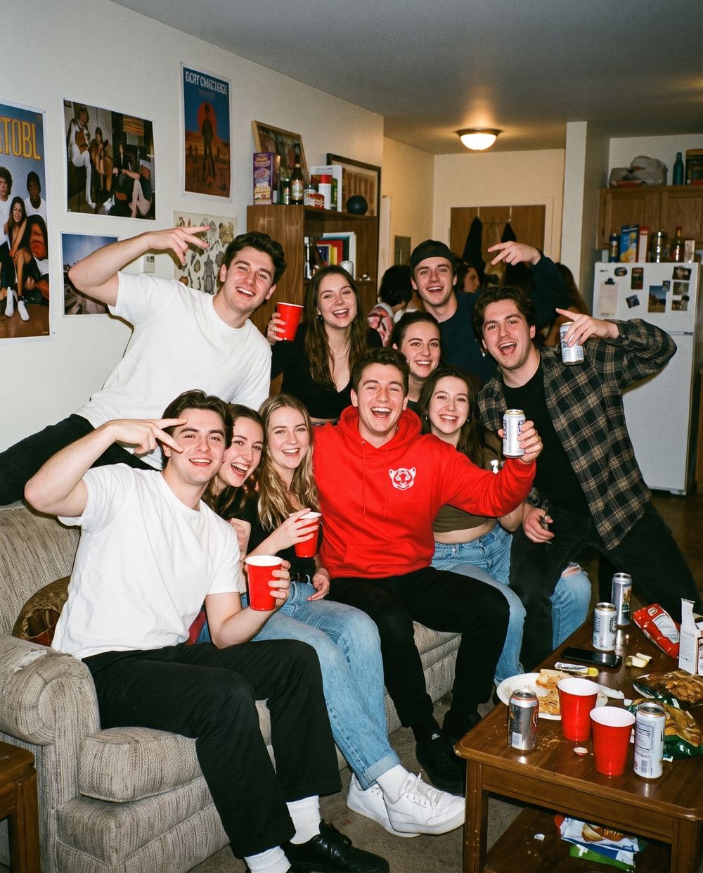 House party couch group photo with a Cub Hoodie